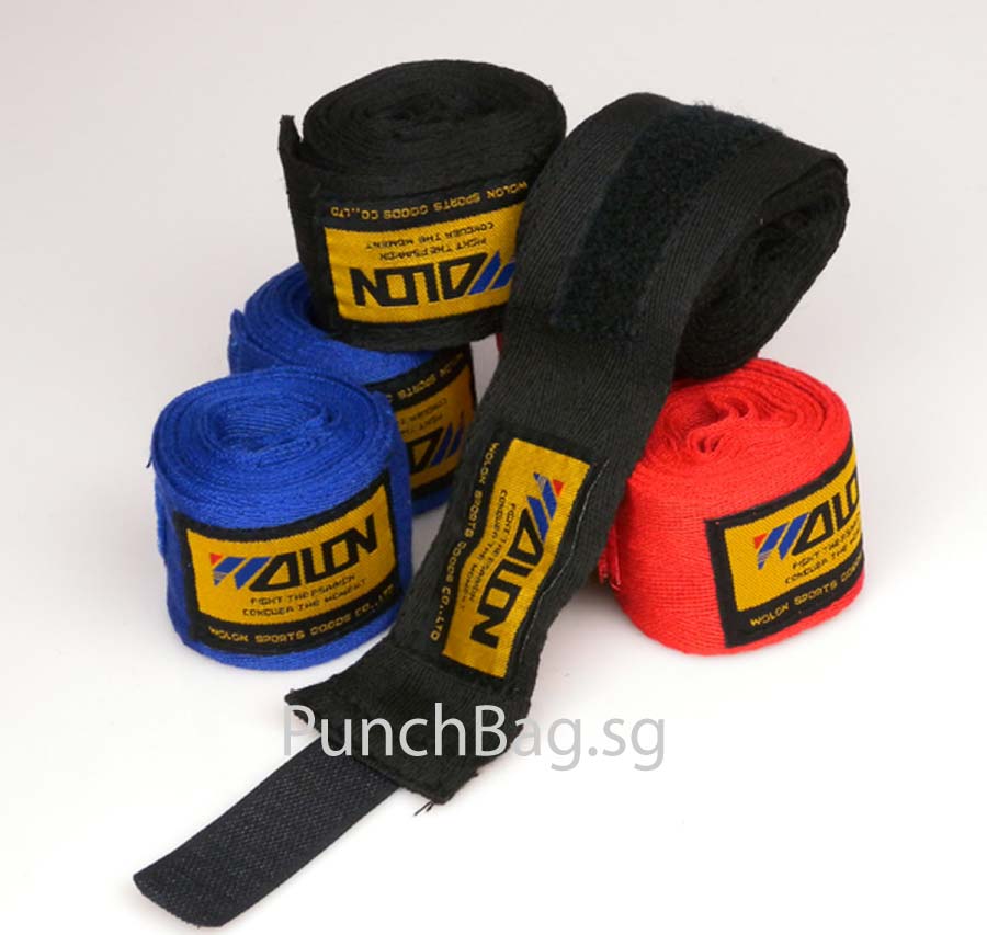 Red woven cotton boxing hand wrap, 2.4 metres long, rolled with thumb loop visible